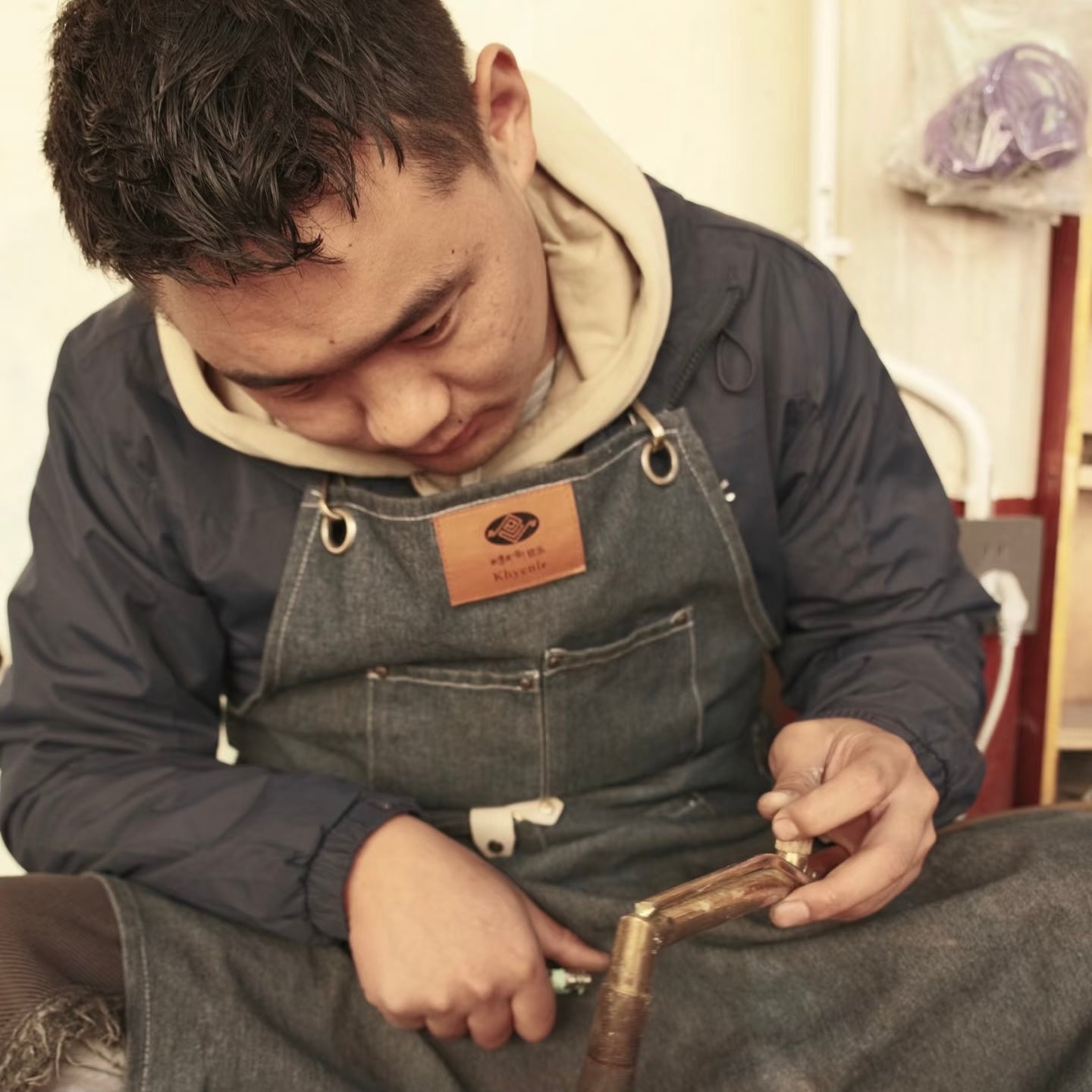 Dawa working on a handcrafted piece