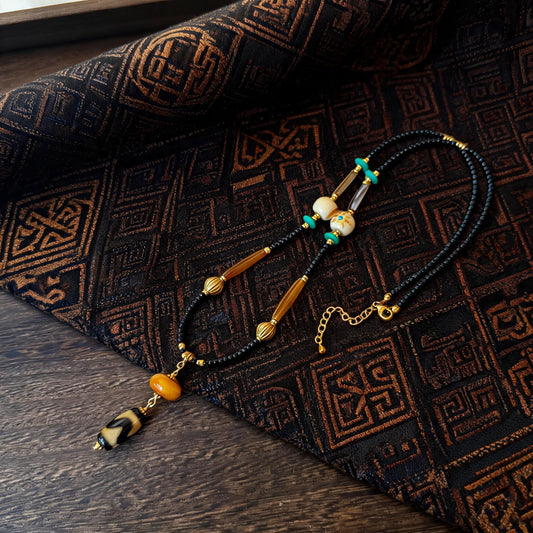 Kumbu tiger tooth dzi bead amber necklace main flat lay