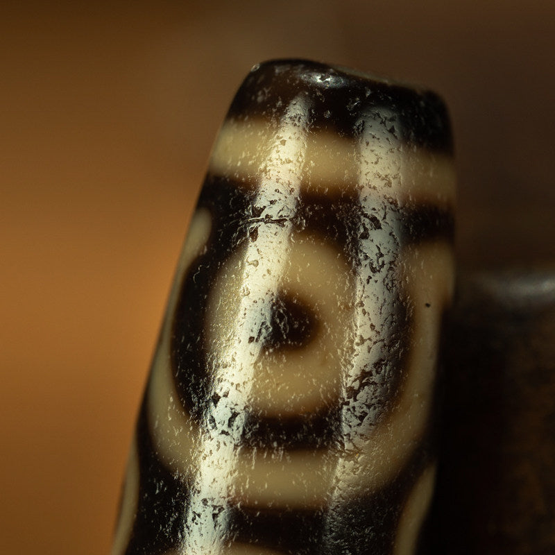 Tibetan dzi bead six eye motif close up