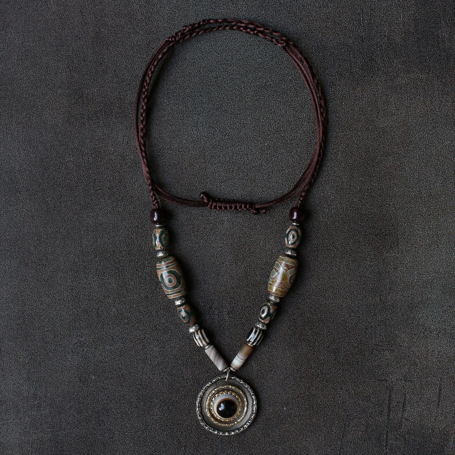 handcrafted Nepalese medicine eye Dzi bead necklace gray white front view