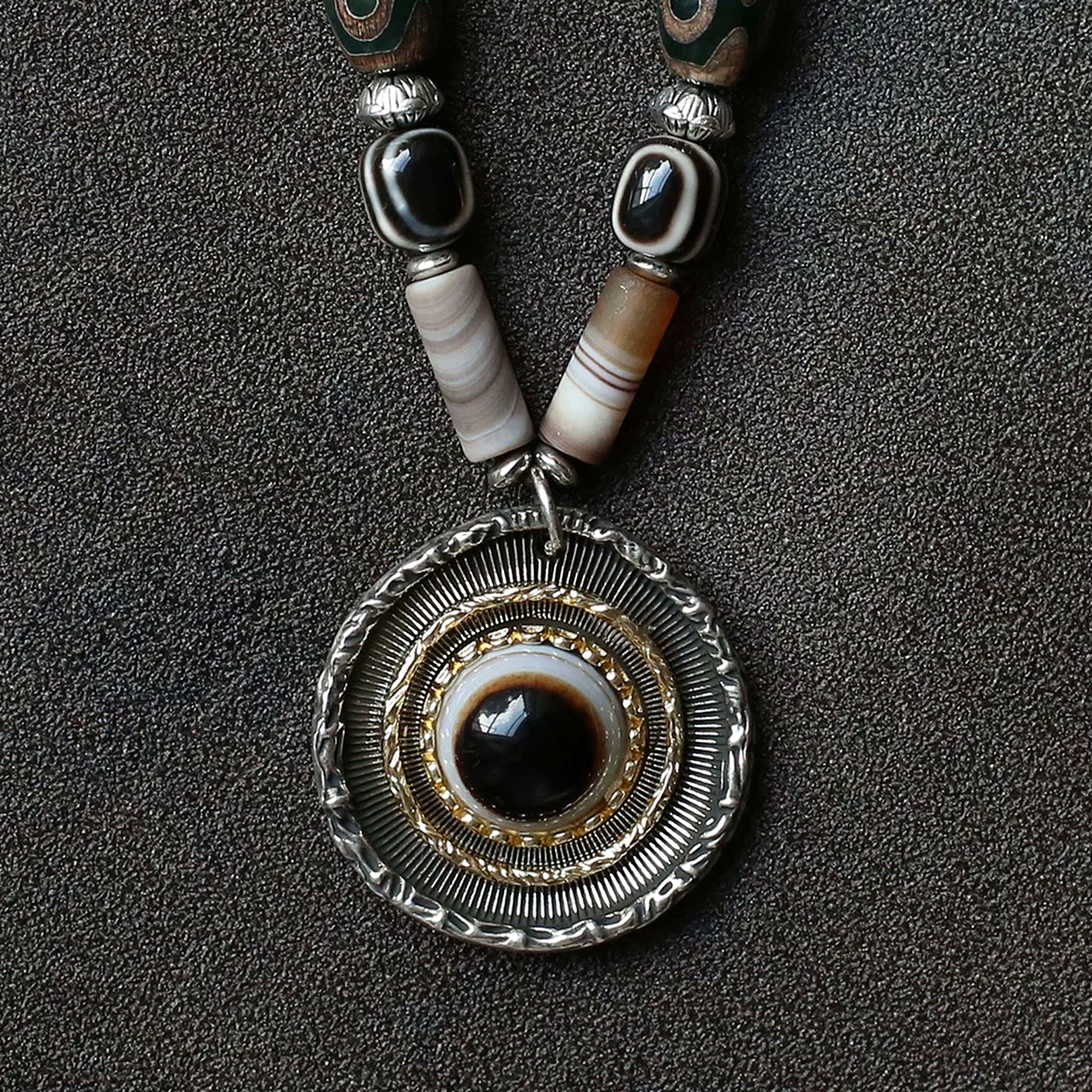 handcrafted Nepalese medicine eye Dzi bead necklace gray white round eye pendant detail