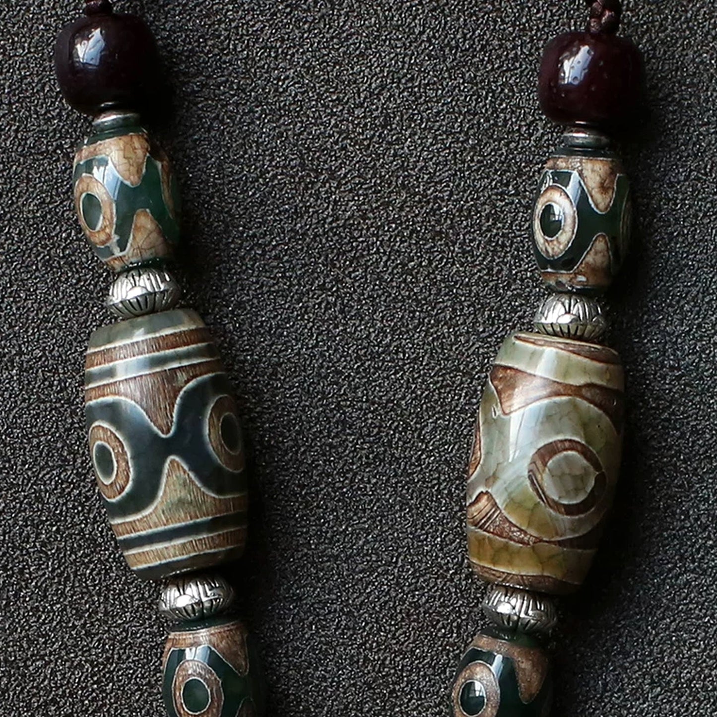 handcrafted Nepalese medicine eye Dzi bead necklace gray white cord and accessory detail