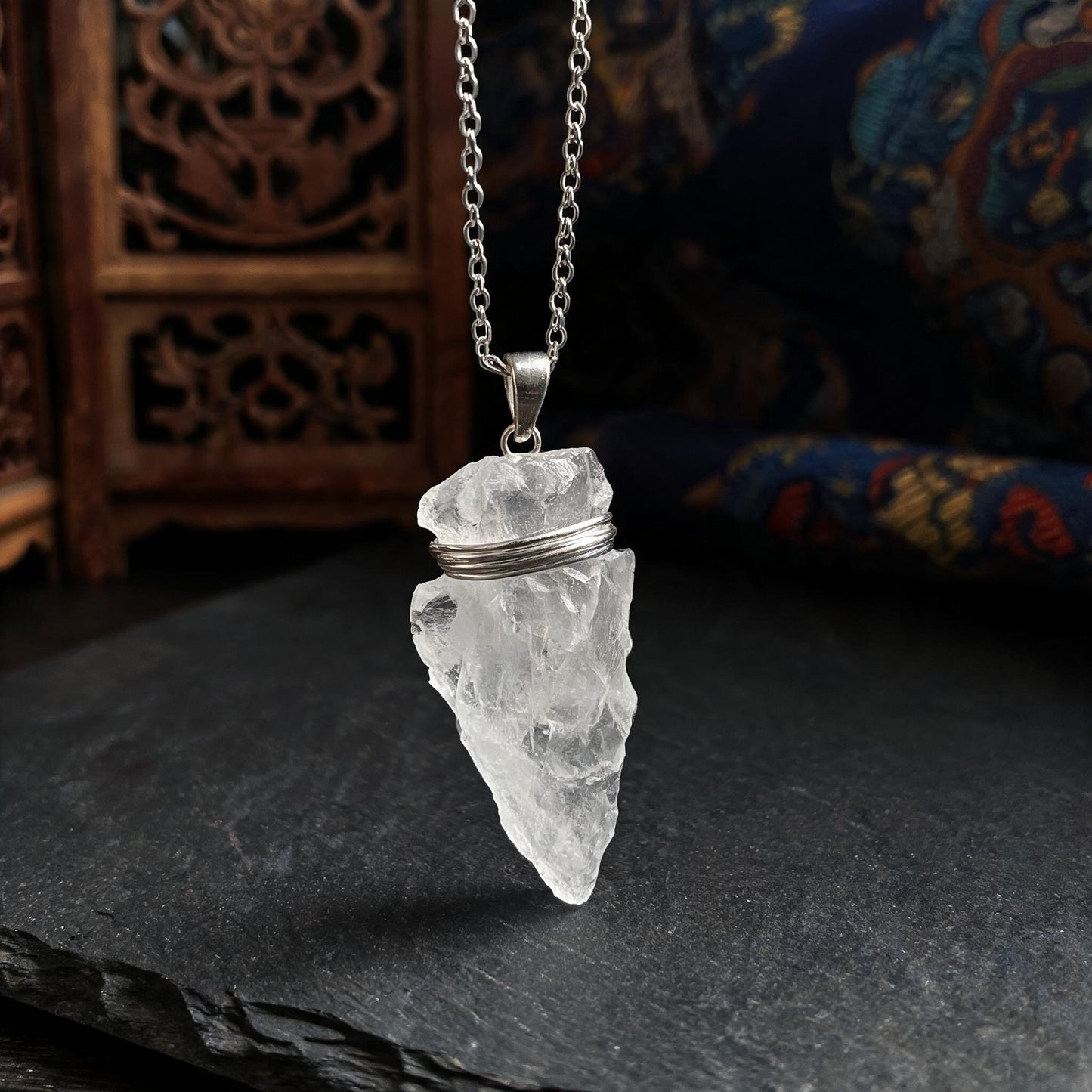 Clear quartz arrowhead pendant necklace with silver chain three quarter view
