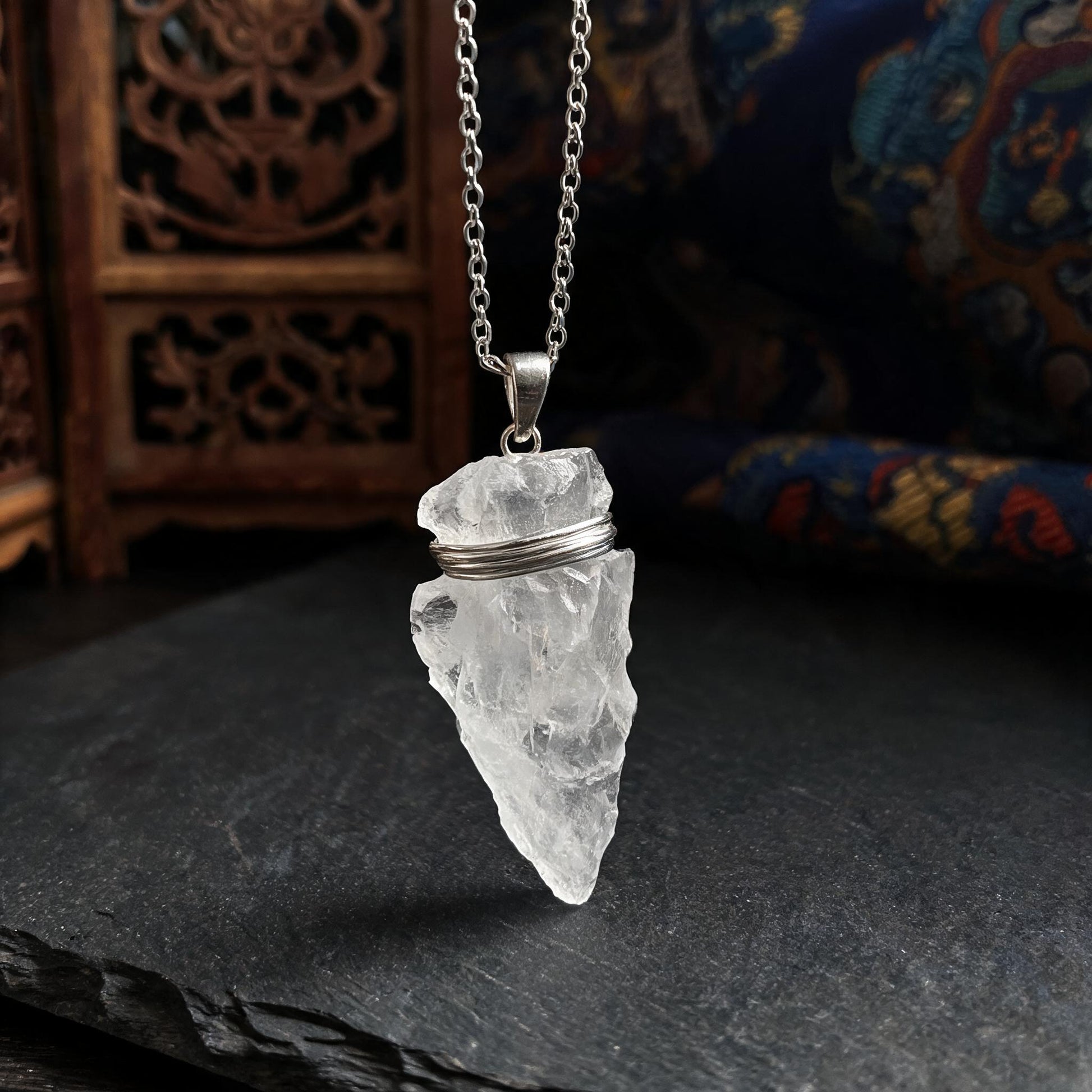 Clear quartz arrowhead pendant necklace with silver chain three quarter view