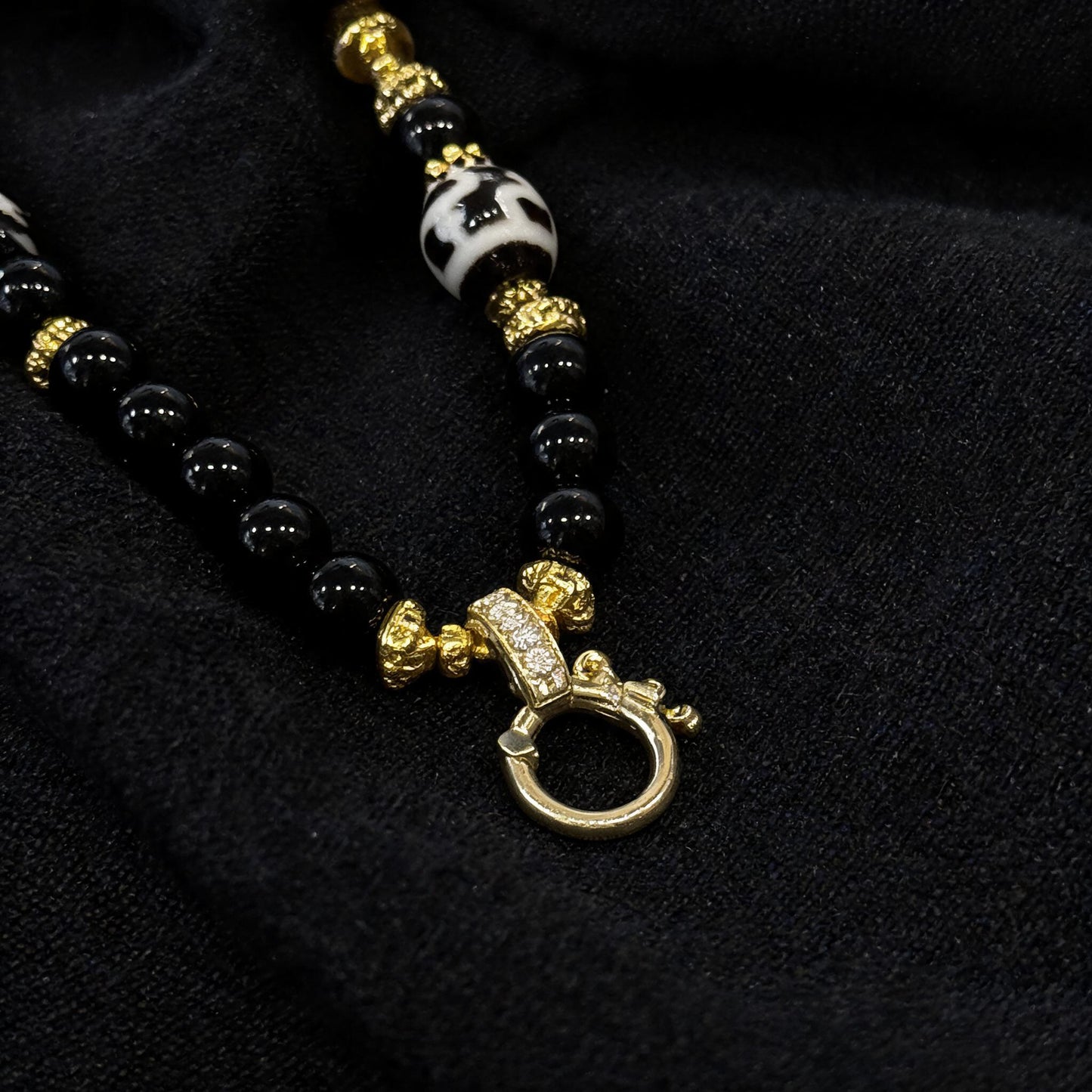 Design M dzi bead pendant detail close-up